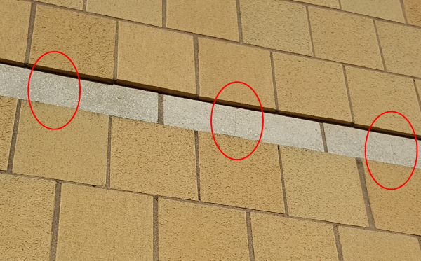 Figure 8: Approximately 80% of all CMU units are cracked in the accent bands on this large hospital project due to differential movement of the shrinking CMU band bonded to large expanses of clay brick veneer. 